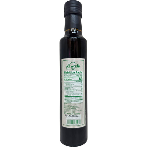 Close-up of Alwadi natural pomegranate molasses, no added sugar, showcasing its rich color and texture, perfect for adding sweetness to dishes.