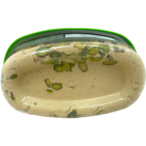 Slice of Four season halva with pistachios, demonstrating the rich flavor and enticing appearance. Ideal for sharing or gifting.