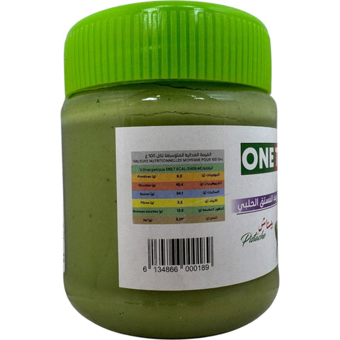 One Two Three Algerian pistachio paste spread on a slice of bread, demonstrating its smooth consistency and vibrant flavor.