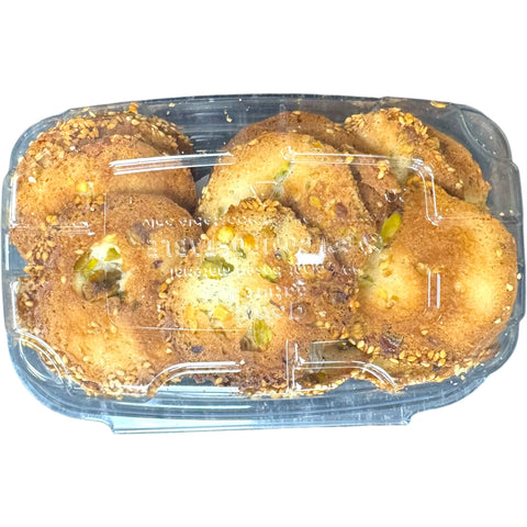 Top view of Albasha Barazek cookies with nuts in a transparent container, emphasizing the variety and appearance of the treats.