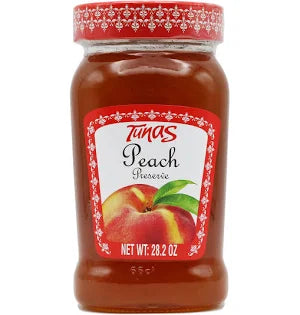 A jar of Tunas Peach Jam Preserve, showcasing its vibrant orange color, with a label prominently displaying the product name 'Tunas Peach Preserve'. The jar has a decorated red lid and is filled to showcase the rich texture of the jam, emphasizing its fruity appeal and deliciousness. Size indicated is 800 grams (28.2 ounces).