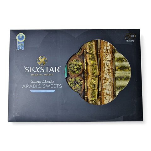 Al Nejmah Sweets assorted baklava package presented in a traditional style, Super size (500g) with multiple baklava varieties.