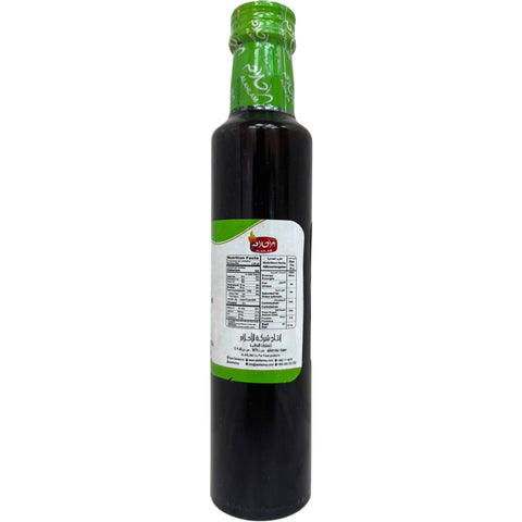 Al ahlam pomegranate molasses 350g - Close-up view of the bottle featuring the label and detailed ingredients of pomegranate molasses.
