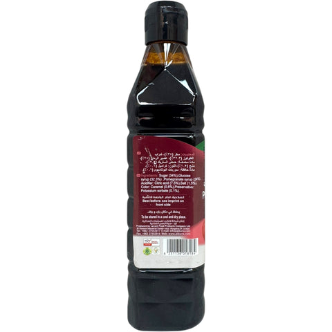 Durra pomegranate molasses being poured into a dish, emphasizing its thick consistency and deep flavor.