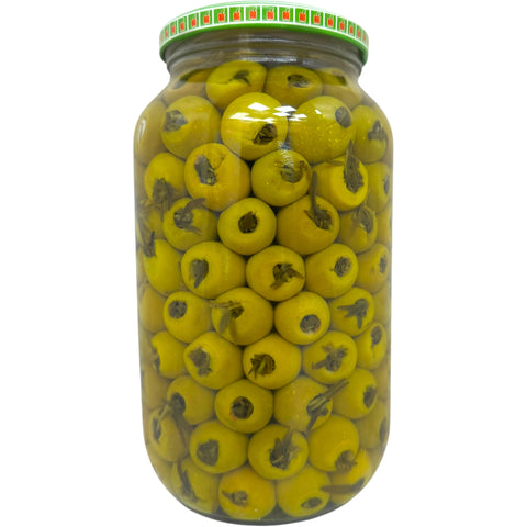 Alahlam green olives, stuffed thyme, beautifully arranged on a wooden serving platter.