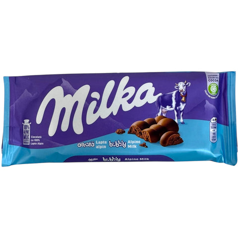 Milka bubbly, alpine milk 90g packaging featuring delicious bubbly chocolate snacks.