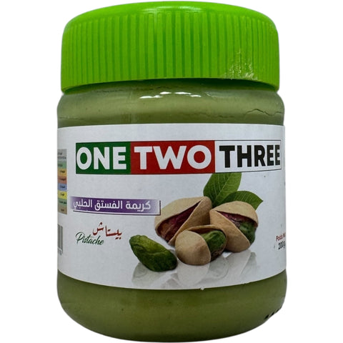 One Two Three Algerian pistachio paste in a jar, showcasing its rich green color and creamy texture, ideal for culinary use.