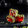 Artfully displayed Turkish delight with pomegranate and pistachio, illustrating the exquisite presentation of this traditional Turkish confection.