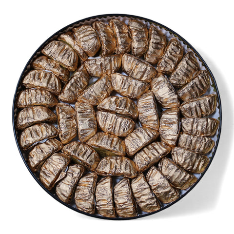 Close-up of Al Nejmah Sweets Walnut Maamoul cookies, a delightful treat wrapped in a stylish package.