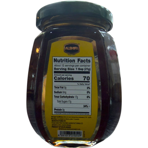 Spoonful of Alshifa Black Forest Honey – 250g against a natural wooden background, highlighting its rich texture and golden color.