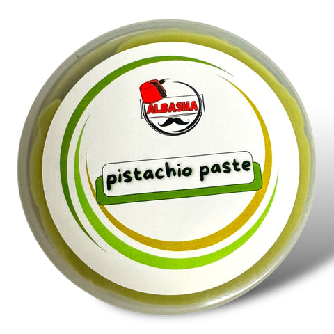 Top view of a round jar of Albanian pistachio paste, with a colorful circular design on the lid and the label stating 'pistachio paste' prominently.