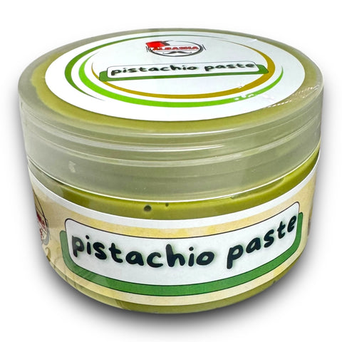 Turkish pistachio paste in a round container labeled as 'pistachio paste', showcasing a rich green color, ideal for culinary use.