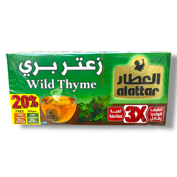 Alattar Wild Thyme packaging featuring a transparent glass of brewed wild thyme tea, with vibrant green leaves surrounding it. The box prominently displays the product name in Arabic and English, highlighting a 20% free offer and suggesting a value of three times the individual tea bag quantity.
