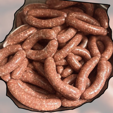 Handcrafted savory lamb and beef sausage links, piled on top of each other, showcasing their rich, artisanal texture and form. Perfect for grilling or breakfast, these sausage links highlight the quality and flavor of premium ingredients.
