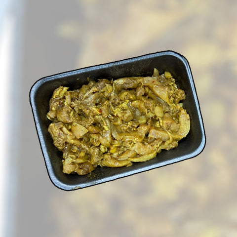 A close-up view of a black tray filled with flavorful tender chicken shawarma, featuring marinated pieces of chicken showcasing spices and herbs, from brewer livestock. This halal meat option is perfect for those seeking delicious and nutritious meals.