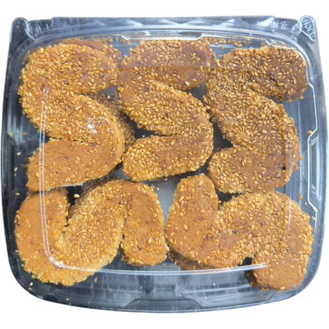 A close-up view of S-Shaped Sesame Cookies – Olive Mountain Bakery, highlighting their golden-brown color and sesame seeds.