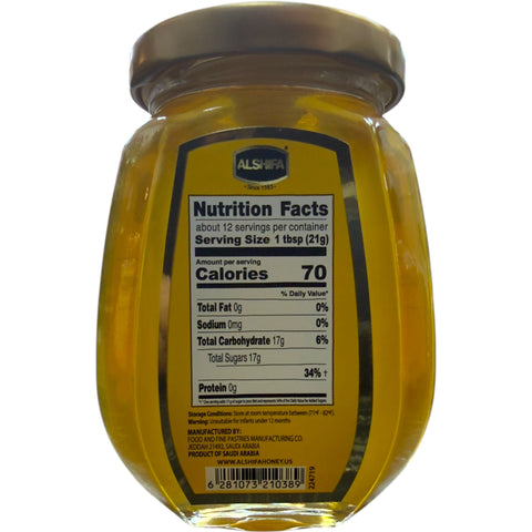 Alshifa Acacia Honey – 250g with a spoonful of honey highlighting its smooth texture and rich flavor.