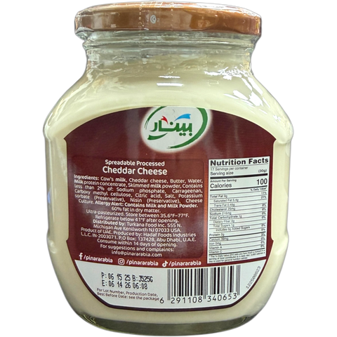 Close-up of Pinar Premium Cheddar Cheese slices arranged artfully on a plate, highlighting their rich yellow color.