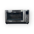 Interior view of the GE Stainless Steel Quartz Convection Toaster Oven highlighting its multifunctional cooking features.