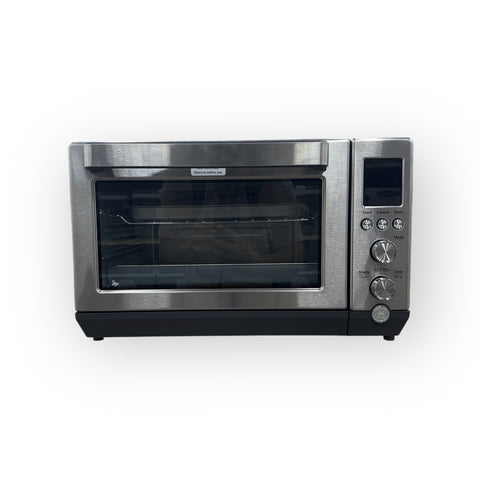 Interior view of the GE Stainless Steel Quartz Convection Toaster Oven highlighting its multifunctional cooking features.