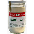 Beirut Kashk Powder in a glass jar, labeled in English and Arabic, showcasing the product name 'Keshk' along with ingredients including milk powder, salt, and ground wheat. The jar contains 16 ounces (454 grams) of the product and features a distinctive tree logo and details about the importer.
