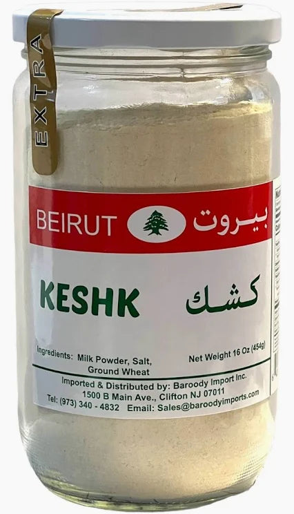 Beirut Kashk Powder in a glass jar, labeled in English and Arabic, showcasing the product name 'Keshk' along with ingredients including milk powder, salt, and ground wheat. The jar contains 16 ounces (454 grams) of the product and features a distinctive tree logo and details about the importer.