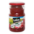 Jar of Tukaş mild pepper paste with red lid and label showing peppers and countryside scene