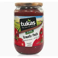 Jar of Tukas Premium Turkish Tomato Paste, 24.7 ounces, featuring a label with tomatoes and the slogan 'We care for nature.' The jar showcases a vibrant red tomato paste inside, emphasizing quality ingredients.