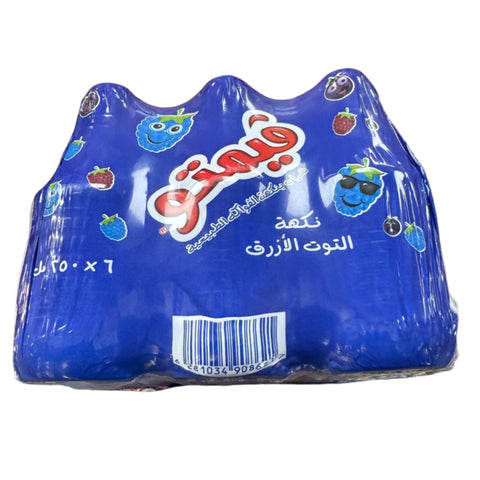 Vimto fruit flavoured Blue Raspberry drink packaging, featuring vibrant blue color and playful fruit illustrations, includes a barcode and text in Arabic.